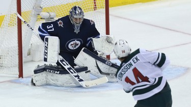 Winnipeg Jets goaltender Connor Hellebuyck stares down a shot from Minnesota Wild centre Joel Eriksson Ek during Game 1 of their first-round NHL playoff series in Winnipeg on Wed., April 11, 2018. Kevin King/Winnipeg Sun/Postmedia Network