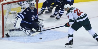 Minnesota Wild forward Nino Niederreiter can't control a bouncing puck in front of Winnipeg Jets goaltender Connor Hellebuyck during Game 1 of their first-round NHL playoff series in Winnipeg on Wed., April 11, 2018. Kevin King/Winnipeg Sun/Postmedia Network