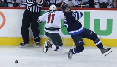 Winnipeg Jets forward Mathieu Perreault (right) is spilled by Minnesota Wild forward Zach Parise during Game 1 of their first-round NHL playoff series in Winnipeg on Wed., April 11, 2018. Kevin King/Winnipeg Sun/Postmedia Network