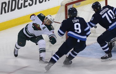 Minnesota Wild forward Zach Parise (left) is spun around after scoring against the Winnipeg Jets during Game 1 of their first-round NHL playoff series in Winnipeg on Wed., April 11, 2018. Kevin King/Winnipeg Sun/Postmedia Network