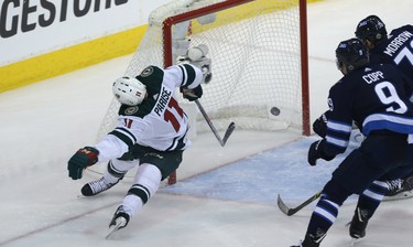 Minnesota Wild forward Zach Parise (left) is spun around after scoring against the Winnipeg Jets during Game 1 of their first-round NHL playoff series in Winnipeg on Wed., April 11, 2018. Kevin King/Winnipeg Sun/Postmedia Network