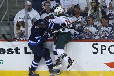 Winnipeg Jets defenceman Ben Chiarot (left) hits Minnesota Wild forward Zach Parise during Game 1 of their first-round NHL playoff series in Winnipeg on Wed., April 11, 2018. Kevin King/Winnipeg Sun/Postmedia Network