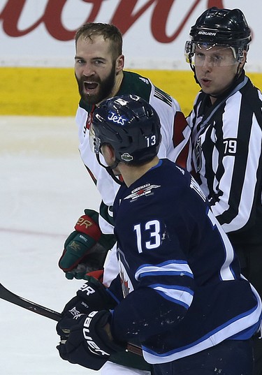 Minnesota Wild forward Daniel Winnik (top) and Winnipeg Jets forward Brandon Tanev have a discussion during Game 1 of their first-round NHL playoff series in Winnipeg on Wed., April 11, 2018. Kevin King/Winnipeg Sun/Postmedia Network