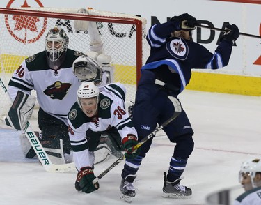 Minnesota Wild defenceman Jared Spurgeon is spilled while duelling with Winnipeg Jets forward Brandon Tanev during Game 1 of their first-round NHL playoff series in Winnipeg on Wed., April 11, 2018. Kevin King/Winnipeg Sun/Postmedia Network