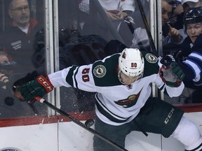 Winnipeg Jets forward Andrew Copp (right) and Minnesota Wild defenceman Carson Soucy collide during Game 2 on Friday.