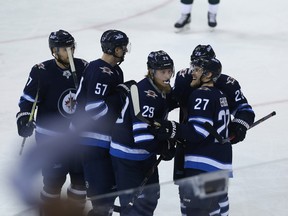 Winnipeg Jets forward Patrik Laine (centre) is congratulated on his goal against the Minnesota Wild during Game 2 of their first-round NHL playoff series in Winnipeg by Ben Chiarot, Tyler Myers, Paul Stastny and Nikolaj Ehlers (from left) on Fri., April 13, 2018. Kevin King/Winnipeg Sun/Postmedia Network