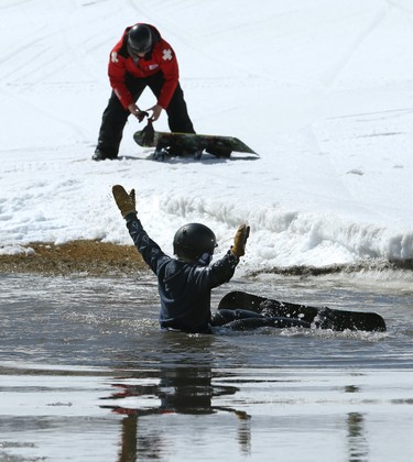 Wyatt Lambert, a 13-year-old from Stonewall, raises his arms in mock celebration after wiping out during the season-ending Slush Cup at Stony Mountain Ski Area in Stony Mountain, Man., on Sun., April 15, 2018. Kevin King/Winnipeg Sun/Postmedia Network