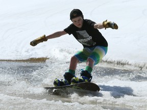 Damien Harrison, 13, crosses the pond during the season-ending Slush Cup at Stony Mountain Ski Area on Sunday.