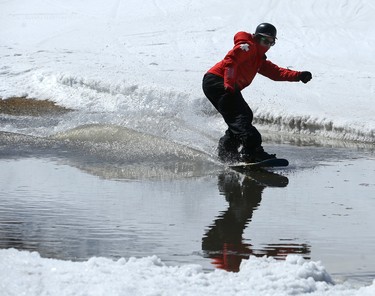 A Ski Patrol member crosses the pond during the season-ending Slush Cup at Stony Mountain Ski Area in Stony Mountain, Man., on Sun., April 15, 2018. Kevin King/Winnipeg Sun/Postmedia Network