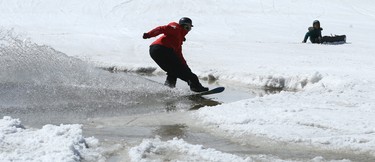 A Ski Patrol member crosses the pond during the season-ending Slush Cup at Stony Mountain Ski Area in Stony Mountain, Man., on Sun., April 15, 2018. Kevin King/Winnipeg Sun/Postmedia Network