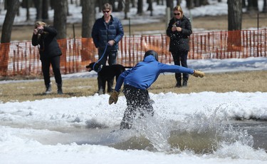 A snowboarder crosses the pond during the season-ending Slush Cup at Stony Mountain Ski Area in Stony Mountain, Man., on Sun., April 15, 2018. Kevin King/Winnipeg Sun/Postmedia Network