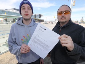 Peter Townsend (left, with WiseUp Winnipeg's Todd Dube) displays a letter he got from Manitoba Justice indicating that they had lost information regarding a traffic ticket that he had thought was resolved.
