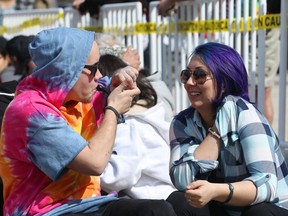 Participants puff during the 4/20 event on the Manitoba Legislative Building grounds in Winnipeg on Friday.
