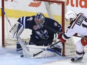 Manitoba Moose goaltender Eric Comrie stops Grand Rapids Griffins centre Ben Street during Game 2 of their AHL division semi-final in Winnipeg on Sun., April 22, 2018. Comrie made 45 saves against the Griffins to give the Moose a 2-1 series lead.