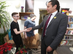 Manitoba NDP leader Wab Kinew shakes hands with Sam MacKinnon (left) at the Rainbow Resource Centre, in Winnipeg.  Kinew announced that he would push Manitoba to allow gender neutral government identification.   Tuesday, April 24, 2018.   Sun/Postmedia Network