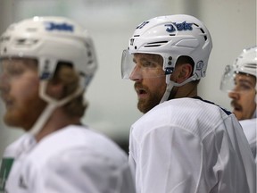 Blake Wheeler (centre), between Kyle Connor (left) and Mark Scheifele, waits his turn during Winnipeg Jets practice at Bell MTS Iceplex in Winnipeg on Tues., April 24, 2018. Kevin King/Winnipeg Sun/Postmedia Network