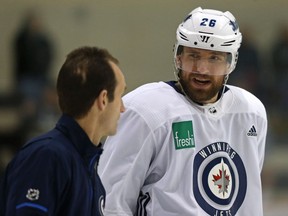 Blake Wheeler (right) chats with assistant coach Jamie Kompon during Winnipeg Jets practice at Bell MTS Iceplex on Tuesday.