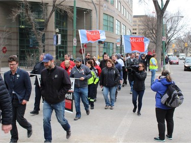 The annual National Day of Mourning Safe Workers of Tomorrow Leaders' Walk for workers killed, injured or became ill due to workplace hazards and incidents heads down Broadway towards Memorial Park in Winnipeg on Friday, April 27, 2018. The 21st annual walk was culminated with a reading of the names of the 27 workers killed in 2017 and the official ground-breaking for the Manitoba Workers' Memorial to honour Manitoba firefighters, peace officers, and workers who have lost their lives while at work.