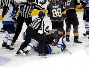 Golden Knights’ Ryan Carpenter takes down Jets’ Mark Scheifele after the whistle during Game 3 last night in Las Vegas. (Getty Images)