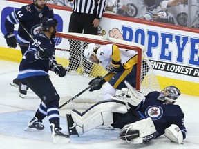 WINNIPEG, MANITOBA - MAY 1: Filip Forsberg #9 of the Nashville Predators ends up in the net behind Connor Hellebuyck #37 of the Winnipeg Jets in Game Three of the Western Conference Second Round during the 2018 NHL Stanley Cup Playoffs on May 1, 2018 at Bell MTS Place in Winnipeg, Manitoba, Canada. (Photo by Jason Halstead /Getty Images)