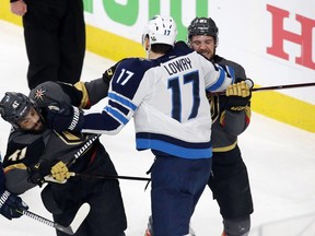 LAS VEGAS, NV - MAY 16: Adam Lowry #17 of the Winnipeg Jets mixes it up with Pierre-Edouard Bellemare #41 and Shea Theodore #27 of the Vegas Golden Knights after the whistle during the third period in Game Three of the Western Conference Finals during the 2018 NHL Stanley Cup Playoffs at T-Mobile Arena on May 16, 2018 in Las Vegas, Nevada.  (Photo by Isaac Brekken/Getty Images)