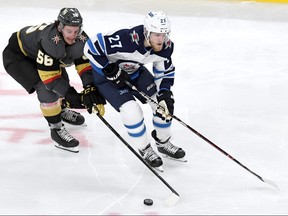 Erik Haula (56) of the Vegas Golden Knights battles for the puck with Nikolaj Ehlers (27) of the Winnipeg Jets during the third period in Game 4 Friday.