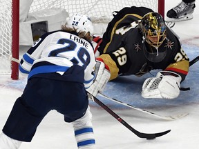 Marc-Andre Fleury (29) of the Vegas Golden Knights makes a diving save against Patrik Laine (29) of the Winnipeg Jets during Game 4 of the Western Conference Final Friday in Las Vegas.