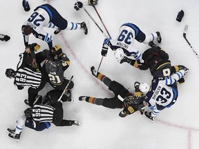 Winnipeg Jets defenceman Dustin Byfuglien grabs two Vegas Golden Knights players during Game 3 action in Las Vegas on Wednesday, May 16, 2018.