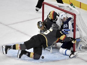 Winnipeg Jets' Mark Scheifele (right) crashes into Vegas Golden Knights goaltender Marc-Andre Fleury and forward Erik Haula (left) during the third period of Game 3 on Wednesday, May 16, 2018, in Las Vegas. (AP/PHOTO)