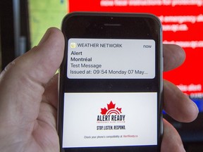 A smartphone and a television receive visual and audio alerts to test Alert Ready, a national public alert system Monday, May 7, 2018 in Montreal.THE CANADIAN PRESS/Ryan Remiorz ORG XMIT: RYR103