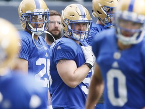 New addition to the Winnipeg Blue Bombers Adam Bighill (50) watches drills with Jhurell Presley (25) at a pre-season training camp in Winnipeg Thursday, May 24, 2018. THE CANADIAN PRESS/John Woods ORG XMIT: JGW108