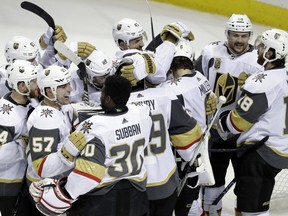 Vegas Golden Knights players hug after a 3-0 win over the San Jose Sharks during Game 6 of an NHL hockey second-round playoff series, Sunday, May 6, 2018, in San Jose, Calif. (AP Photo/Marcio Jose Sanchez) ORG XMIT: SJA114