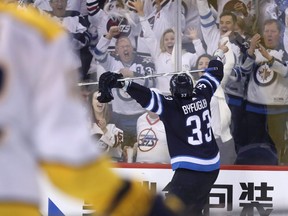 Winnipeg Jets' Dustin Byfuglien (33) celebrates after scoring against the Nashville Predators during second period NHL hockey playoff action in Winnipeg on Tuesday May 1, 2018. THE CANADIAN PRESS/Trevor Hagan ORG XMIT: WPGT131