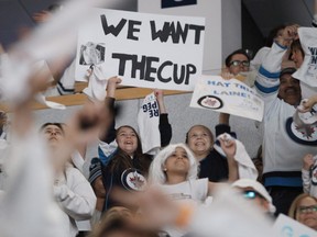 Winnipeg Jets fans at a viewing party react after the Jets defeated Nashville Predators in NHL playoff action in Winnipeg on Thursday, May 10, 2018. THE CANADIAN PRESS/John Woods ORG XMIT: JGW133