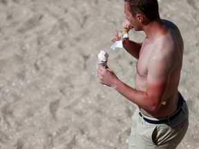 In this file photo taken on June 17, 2017 a man with sunburn eats ice cream. If Manitoba's forecast holds, ice cream days will be plentiful this summer, as will sunburns if you don't protect yourself.
CHARLY TRIBALLEAUCHARLY TRIBALLEAU/AFP/Getty Images