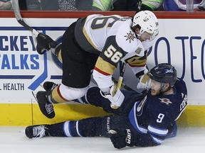 Vegas Golden Knights' Erik Haula (56) and Winnipeg Jets' Andrew Copp (9) collide during third period NHL action in Winnipeg on Thursday, February 1, 2018. (THE CANADIAN PRESS/John Woods)