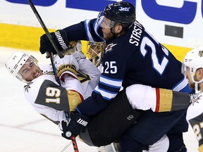 Reilly Smith of the Vegas Golden Knights is checked by Paul Stastny of the Winnipeg Jets during Game Two of the Western Conference final at Bell MTS Place on May 14, 2018 in Winnipeg.  (Jason Halstead/Getty Images)