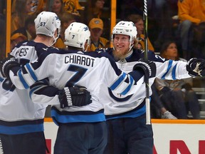 Tyler Myers , Ben Chiarot, and Patrik Laine of the Winnipeg Jets celebrate after a goal against the Nashville Predators at Bridgestone Arena on May 10, 2018 in Nashville. (Frederick Breedon/Getty Images)