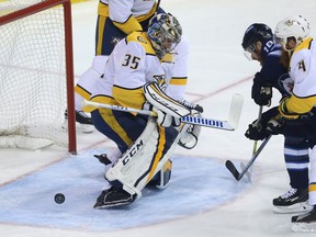 Winnipeg Jets forward Bryan Little’s shot is stopped by Preds goaltender Pekka Rinne last night. (Kevin King/Winnipeg Sun)