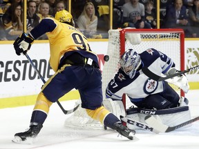 Winnipeg Jets goalie Connor Hellebuyck (37) blocks a shot by Nashville Predators center Ryan Johansen (92) during the second period in Game 5 of an NHL hockey second-round playoff series Saturday, May 5, 2018, in Nashville, Tenn. (AP Photo/Mark Humphrey) ORG XMIT: TNMH106