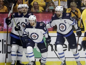 Winnipeg Jets left wing Kyle Connor (81) celebrates with Josh Morrissey, Mark Scheifele and Blake Wheeler, from left, after Connor scored a goal against the Nashville Predators during the second period in Game 5.