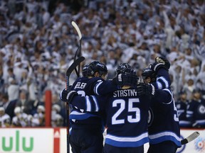 Jets’ Mark Scheifele (left) congratulates defenceman Dustin Byfuglien on his goal against the Vegas Golden Knights during Game 1 of their Western Conference final on Saturday night in Winnipeg. (KEVIN KING/WINNIPEG SUN)