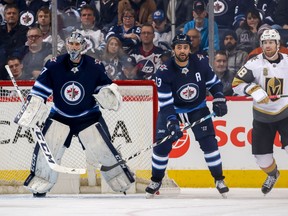WINNIPEG, MB - FEBRUARY 1: Goaltender Connor Hellebuyck #37, Dustin Byfuglien #33 of the Winnipeg Jets and James Neal #18 of the Vegas Golden Knights keep an eye on the play during second period action at the Bell MTS Place on February 1, 2018 in Winnipeg, Manitoba, Canada. The Knights defeated the Jets 3-2 in overtime. (Photo by Jonathan Kozub/NHLI via Getty Images) ORG XMIT: 775041302