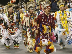 Dancers participate in the grand entry during a powwow at the Manito Ahbee Festival at MTS Centre.