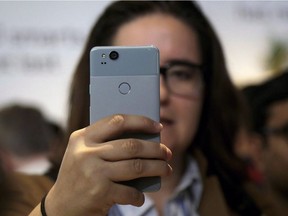 A woman looks at a Google Pixel 2 phone at a Google event at the SFJAZZ Center in San Francisco, October 4, 2017. Canada's wireless providers are preparing for a looming update to the National Public Alerting System that will force smartphones to sound an ominous alarm when an emergency alert is triggered. In a case of emergencies including Amber Alerts, forest fires, natural disasters, terrorist attacks or severe weather, officials will be able to send a localized alert that will compel compatible phones on an LTE network to emit an alarm -- the same shrill beeping that accompanies TV and radio emergency alerts -- and display a bilingual text warning.