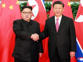 In this May 7, 2018, photo provided by the North Korean government, North Korean leader Kim Jong Un, left, meets Chinese President Xi Jinping in Dalian, China.