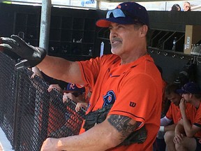 Cleburne Railroaders newly signed player and former Major League player, Rafael Palmeiro, talks with reporters from the dugout after a spring training baseball game in Cleburne, Texas, on May 10, 2018