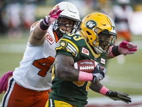 Edmonton's Shakir Bell (33) is tackled by B.C.'s Adam Bighill (44) during the first half of CFL action between the Edmonton Eskimos and the B.C. Lions at Commonwealth Stadium in Edmonton, Alta.. on Saturday October 17, 2015. Ian Kucerak/Edmonton Sun/Postmedia Network