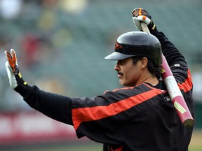 In this Aug. 15, 2005, file photo, Baltimore Orioles' Rafael Palmeiro waves to fans as he prepares to take batting practice for the team's baseball game against the Oakland Athletics in Oakland, Calif. Palmeiro says he has agreed to play with his son Patrick for the independent Cleburne (Texas) Railroaders at age 53.