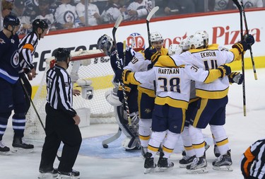 Winnipeg Jets goaltender Connor Hellebuyck fishes the puck out of the net after Nashville Predators centre Mike Fisher scored during Game 2 of their second-round playoff series in Winnipeg on Tues., May 1, 2018. Kevin King/Winnipeg Sun/Postmedia Network